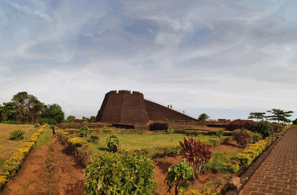 Side view of Bekal Fort in Kasaragod, Kerala, overlooking the Arabian Sea with historic stone walls and lush greenery